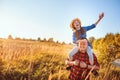 Happy father and daughter walking on summer meadow, having fun and playing. Royalty Free Stock Photo