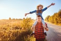 Happy father and daughter walking on summer meadow, having fun and playing. Royalty Free Stock Photo