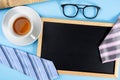 Happy Father Day background concept with blue and pink necktie glasses, newspaper, cup of tea and blackboard on blue background