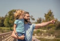 happy father directing showing something his child outdoor, childhood Royalty Free Stock Photo
