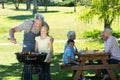 Happy father doing barbecue with his daughter Royalty Free Stock Photo