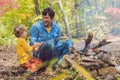 Happy father doing barbecue with his son on an autumn day Royalty Free Stock Photo