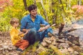 Happy father doing barbecue with his son on an autumn day Royalty Free Stock Photo