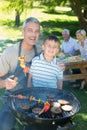 Happy father doing barbecue with his son Royalty Free Stock Photo