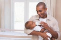 Happy father feeding his baby boy a bottle Royalty Free Stock Photo