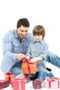 Happy father gives his son gift isolated on white.