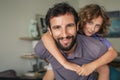 Happy father giving his son a piggyback at home Royalty Free Stock Photo