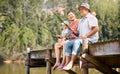 Happy father, grandfather and child fishing at lake together for fun bonding or peaceful time in nature. Dad, grandpa Royalty Free Stock Photo