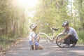 Happy father helped his daughter repair the bike