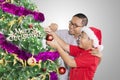 Happy father helping his boy to decorating a fir tree Royalty Free Stock Photo