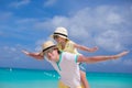 Happy father and his adorable little daughter have fun at tropical beach