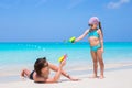 Happy father and his adorable little daughter at tropical beach having fun