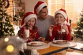Happy father and his children eating delicious Christmas cookies at home Royalty Free Stock Photo