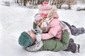 A happy father with his children playing in the snow in the open air