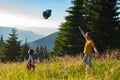 Happy father and his joyful small son are playing on the mountain meadow Royalty Free Stock Photo