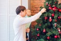 Happy father and his little son decorating the Christmas tree at home. Royalty Free Stock Photo