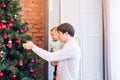 Happy father and his little son decorating the Christmas tree at home. Royalty Free Stock Photo