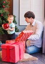 Happy father and his little son decorating the Christmas tree at home. Royalty Free Stock Photo