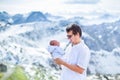 Happy father with his newborn baby in mountains Royalty Free Stock Photo