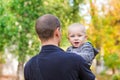 Happy father and his son outdoors. Child hugging daddy. Royalty Free Stock Photo