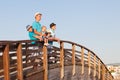 Happy father with his sons and little daughter standing on wooden bridge Royalty Free Stock Photo