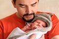 Happy father holding in arms little newborn baby daughter wrapped in towel after bathing. Royalty Free Stock Photo