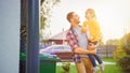 Happy Father Holding a Young Girl. They Threw away Trash into Correct Garbage Bins Because This Royalty Free Stock Photo