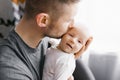 Happy father holds a newborn baby in his arms and kisses him Royalty Free Stock Photo