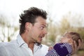 Happy father joking with baby girl