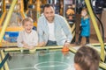happy father with kids playing air hockey Royalty Free Stock Photo