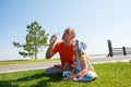 Happy father and a laughing small daughter enthusiastically inflate soap bubbles