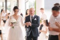 Happy father leading his daughter to the altar. Dad is proud of his beautiful daughter. Wedding ceremony Royalty Free Stock Photo