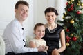 Happy father, little daughter with ring on finger and mother sit