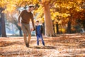 Father and little son playing and having fun outdoors over autumn park background Royalty Free Stock Photo