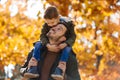 Father and little son playing and having fun outdoors over autumn park background Royalty Free Stock Photo