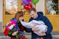 Happy father meets his wife with a newborn baby