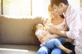 Happy father and mother feeding baby from bottle Royalty Free Stock Photo