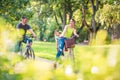 Happy father and mother with kid on bicycles having fun in park. Happy family Royalty Free Stock Photo