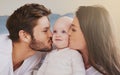 Happy father, mother and kiss baby on cheek for love, care and quality time to relax together in family home. Mom, dad Royalty Free Stock Photo