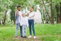 Happy father, mother and son with plastic garbage bag