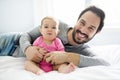 Happy father playing with adorable baby in bedroom Royalty Free Stock Photo