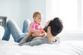 Happy father playing with adorable baby in bedroom Royalty Free Stock Photo