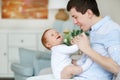 A happy father playing with adorable baby in bedroom. Daddy and daughter Royalty Free Stock Photo