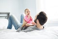 Happy father playing with adorable baby in bedroom Royalty Free Stock Photo