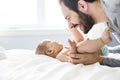 Happy father playing with adorable baby in bedroom Royalty Free Stock Photo