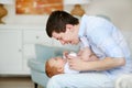 A happy father playing with adorable baby in bedroom. Daddy and daughter Royalty Free Stock Photo