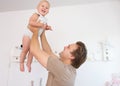Happy father playing with cute baby at home Royalty Free Stock Photo