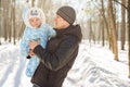 Happy father playing with little child son boy in winter nature Royalty Free Stock Photo
