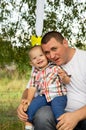 Happy father ride on a swing with son