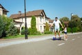 Happy father riding hoverboard together with daughter